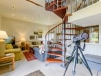 Spiral staircase to upper floor and telescope