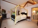 Spacious master bedroom with high ceilings and exposed beams Spacious master bedroom with high ceilings and exposed beams