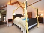 The large four-poster bed takes centre stage The large four-poster bed takes centre stage