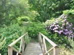 Step over the bridge to explore the naturally landscaped gardens Step over the bridge to explore the naturally landscaped gardens