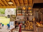 Fabulous outdoor kitchen with Argentine BBQ and gatehouse beyond Fabulous outdoor kitchen with Argentine BBQ and gatehouse beyond