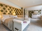 Beautiful king-size bedroom decorated in calming colours