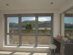 Enjoy the spectacular views from the stylish bedroom over Loch Earn