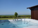 Relax and enjoy a dip in the lovely hot tub and admire the views
