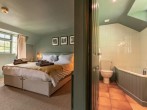 The en-suite enjoys a corner bath and shower The en-suite enjoys a corner bath and shower