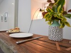 The dining table cleverly crafted from recliamed timbers