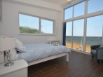 Second double bedroom with floor to ceiling windows to enjoy the view
