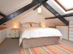 A romantic clog loft bedroom with a large floor space but restricted height