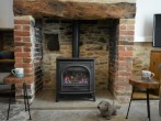 Settle down beside the inglenook fireplace Settle down beside the inglenook fireplace