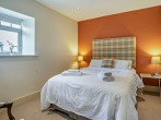 Upstairs to a third king-size bedroom which enjoys sea views