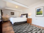 A spacious ground floor bedroom with super-king-size bed