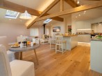 Open-plan lounge/kitchen/diner with feature wood burner 