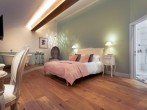 Opulent master bedroom with TV and beautiful en-suite
