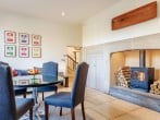 Breakfast by the wood burner in the open plan kitchen and dining area Breakfast by the wood burner in the open plan kitchen and dining area