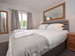 The stylish super-king-size bedroom with ample storage space and Smart TV