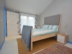 En-suite master bedroom with doors to rear decked area En-suite master bedroom with doors to rear decked area