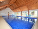 Large indoor heated swimming pool perfect for exercise or family fun