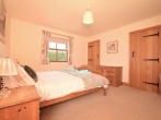 Master bedroom with king-size bed and en-suite shower 