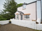A pretty, semi-detached cottage with cute picket fence