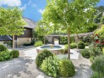 Idyllic garden with a trickling water feature and seating area