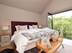 Enjoy the lovely woodland views from the Juliet balcony