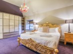 Super-king-size bedroom with stunning gilt bed frame 