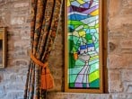 Stained glass window depicting Old Crofftau nestled among the Brecon Beacons Stained glass window depicting Old Crofftau nestled among the Brecon Beacons