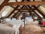 A spacious attic room with four single beds and its own bathroom