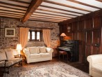 The oak panelled sitting room with piano for you to use